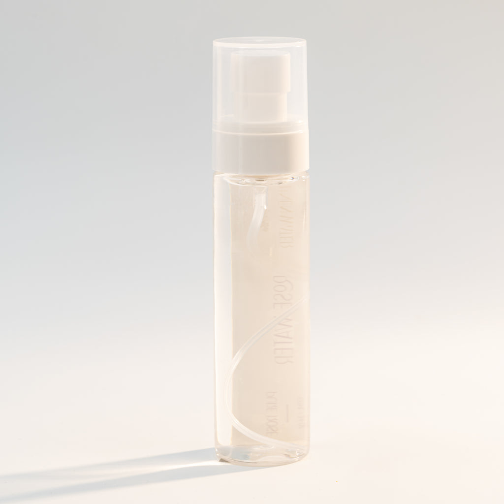 Good Linen Water  A stylish, portable spray bottle containing Rose Water face spray.  displayed against a bright, neutral environment, representing innocence, freshness, and gentle floral care for skin that glows.