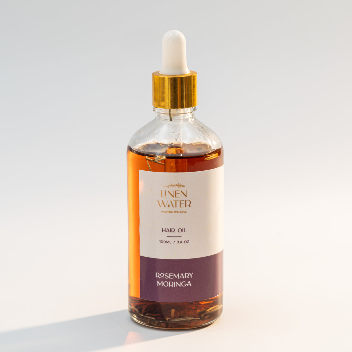 The natural, nourishing blend of Linen Water Rosemary Moringa Hair Oil in this glass dropper bottle strengthens roots, nourishes the scalp, and promotes healthy hair growth.  This herbal hair oil, enhanced with extracts of moringa and rosemary, supports the natural growth of strong, glossy, and silky hair.