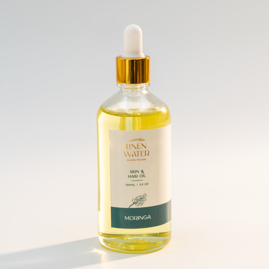 Linen Water Moringa Oil for Skin and Hair, which is rich in natural nutrients and antioxidants, hydrates dry skin, strengthens hair roots, and provides deep nourishment for a healthy, glowing look.  With consistent use, this natural moringa skin and hair oil, which comes in a clear glass bottle with a golden dropper, encourages strong, glossy hair and soft, smooth skin.