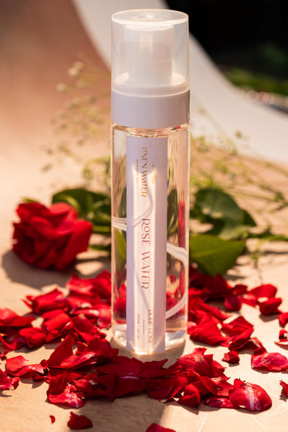 This elegant linen water rose water spray bottle has a transparent body and a white cap.  Amazingly taken in natural light to showcase its purifying, hydrating, and soothing effects for everyday skin refreshment.