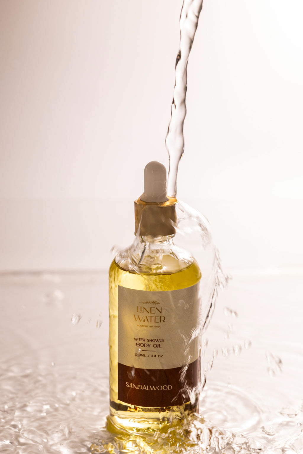 Sandalwood body oil with linen water after shower that moisturizes drying skin, promotes rest, and keeps it smooth and glowing all day.