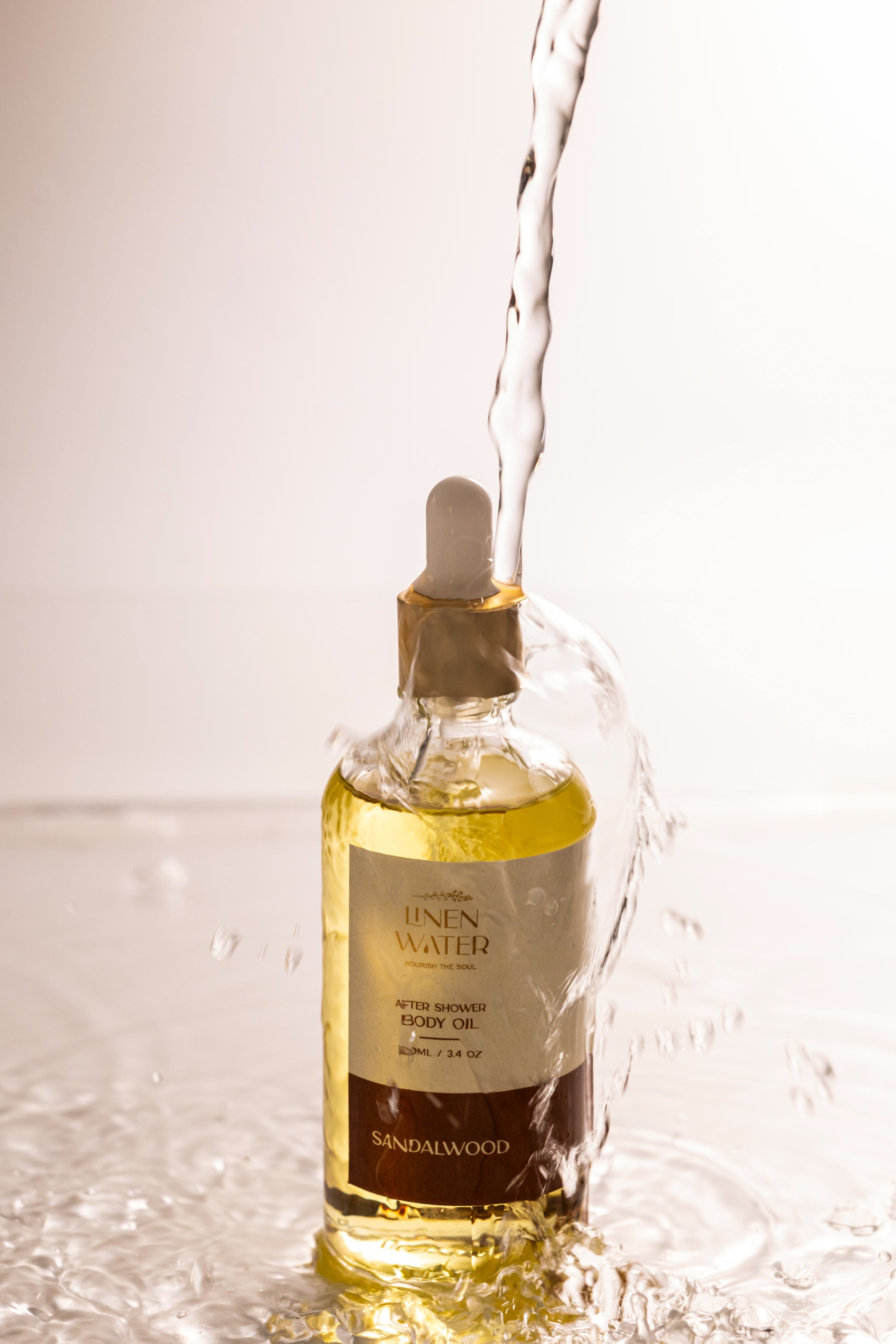 Sandalwood body oil with linen water after shower that moisturizes drying skin, promotes rest, and keeps it smooth and glowing all day.